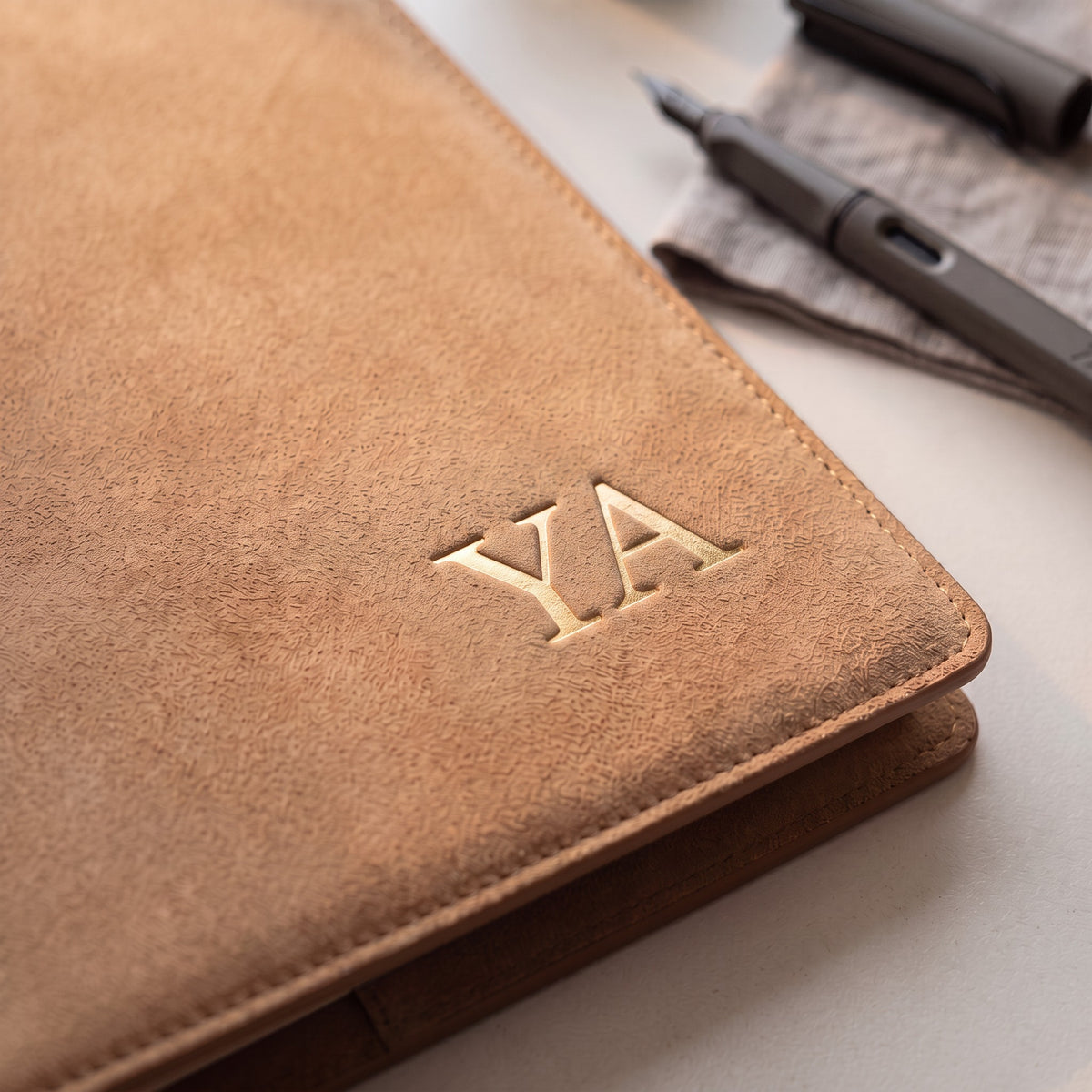 Gold foil embossed name on Noir charcoal leather binder, personalized ring planner by Lumen Stationery